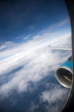 View From an Airplane Window Capturing Clouds and the Wing in Flight Stock Photos