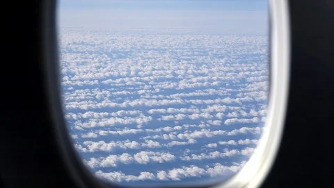 View From Airplane Window To Cloud Cover Illuminated By Sun Video stock 114747412