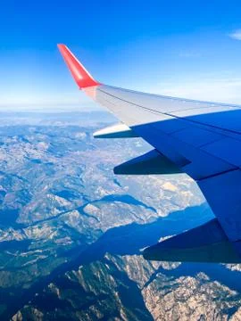 The view from the airplane window on the clouds and mountains. From the windo Stock Photos