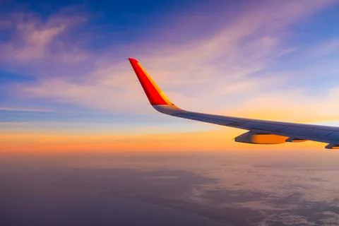 The view from the airplane window to the clouds and sunset. Airplane wing abo Foto stock