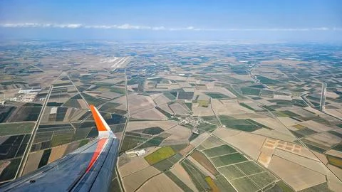 View from airplane window with clouds and blue sky Stock Photos