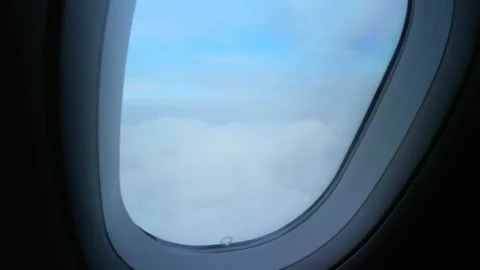 View from the airplane window on the cloudy blue sky Stock Footage 152604300