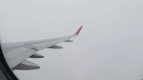 A view from an airplane window during a flight in the clouds. Stock-Footage 162733386