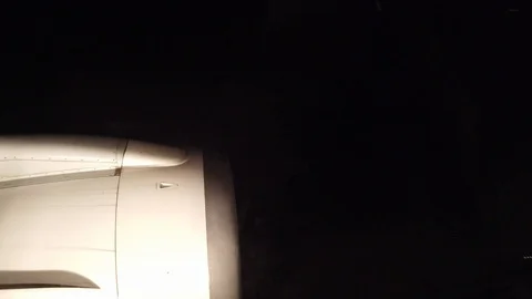 View from airplane window during landing at night Stock Footage 121189405