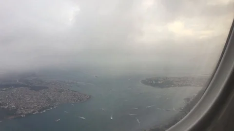 View from airplane window during landing on the ocean with ships Stock Footage 122095195