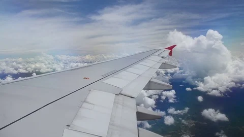 View from the airplane window during sunny cloudy day Stock Footage 70839645