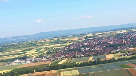 View from airplane window during takeoff over European countryside with pat.. Video stock 338363225