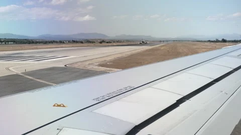 View from an airplane window during takeoff preparation with another aircraf Stock Footage 339353832