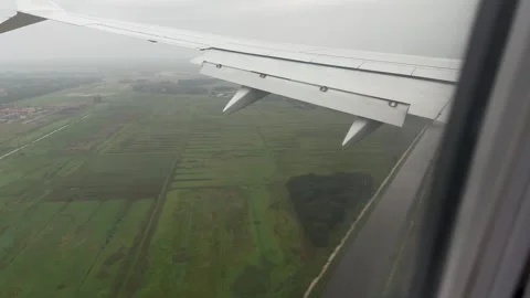 View from airplane window during taking off over flooded fields in Pisa Tuscany Stock Footage 306959821