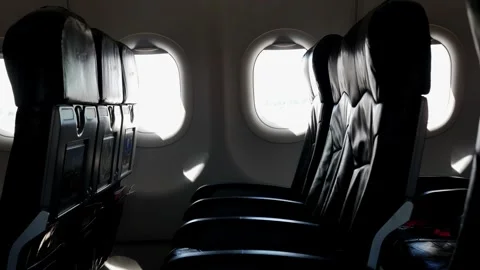 View to the airplane window with empty seat in daytime inside airplane cabin Stock Footage 254152642