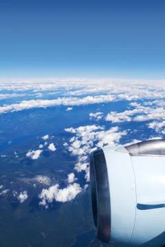View from airplane window with engine above the clouds Stock Photos