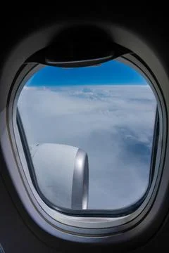 View from an airplane window engine in the clouds Stock Photos