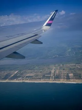 View from the airplane window to the fields and the sea Stock Photos