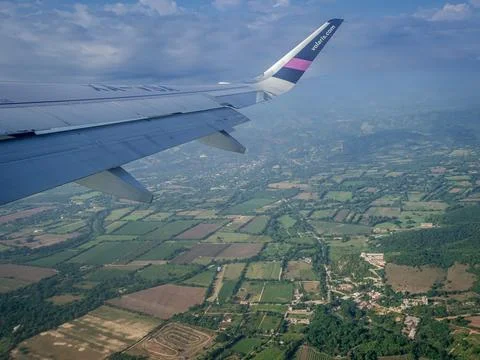 View from the airplane window to the fields and the sea Stock Photos