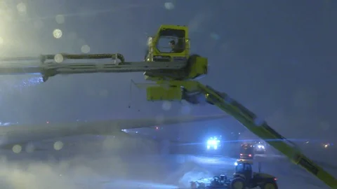 View from airplane window filtered by de-icing liquid being applied at night Video stock 103460141