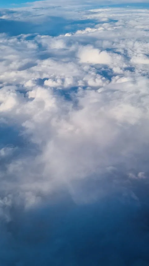 View from the airplane window. Fluffy white clouds are moving slowly Stock Footage 288114594