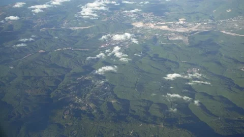 View from airplane window. Fly over land and clouds. Video stock 157205902