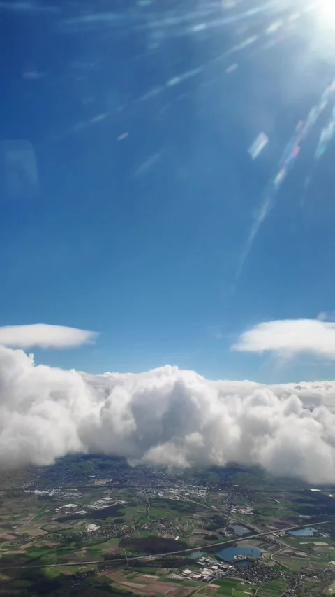 View from the airplane window, flying above the clouds, sunny, vertical Stock Footage 274201434