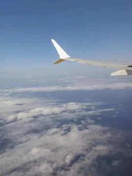 View from the airplane window. Flying between the clouds Stock Photos