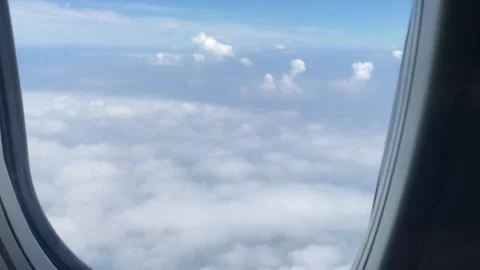 View from the airplane window flying over the clouds Stock Footage 256967458