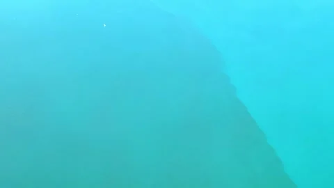 View from an airplane window flying over turquoise water in the sea. Stock Footage 281712998