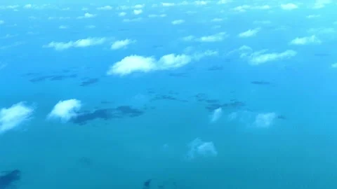 View from an airplane window flying over turquoise water in the sea. Stock-Footage 281714849