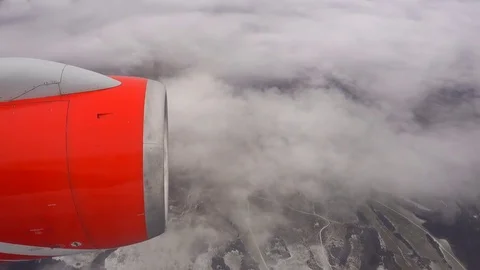 View from the airplane window. In the foreground is the jet engine of the lin Stock Footage 83804815