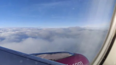 View from an airplane window high above the clouds Video stock 169250749