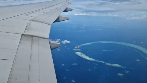 View from the airplane window to the Indian Ocean and the atoll. Maldives Stock Footage 309020347