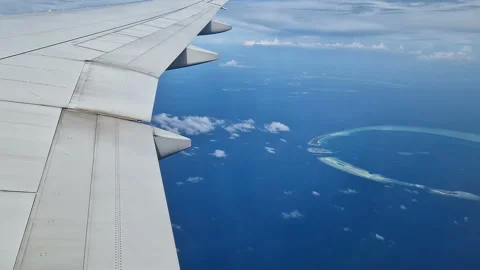 View from the airplane window to the Indian Ocean and the atoll. Maldives Stock Footage 309020348