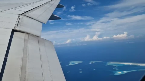 View from the airplane window to the Indian Ocean and the atoll. Maldives Stock Footage 309020644