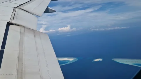 View from the airplane window to the Indian Ocean and the atoll. Maldives Stock Footage 309020654