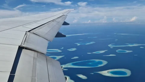 View from the airplane window to the Indian Ocean and the atoll. Maldives Stock Footage 309021043