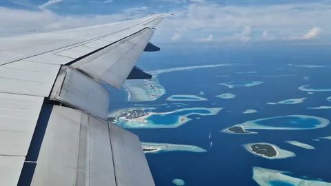View from the airplane window to the Indian Ocean and the atoll. Maldives Stock Footage 309104312