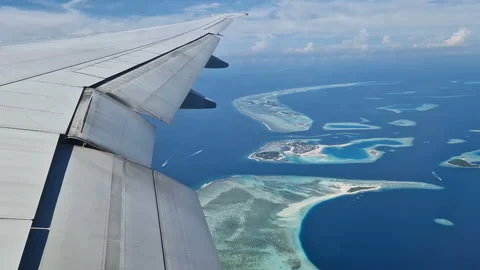 View from the airplane window to the Indian Ocean and the atoll. Maldives Stock Footage 309104338