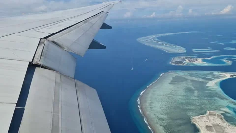 View from the airplane window to the Indian Ocean and the atoll. Maldives Stock Footage 309104650
