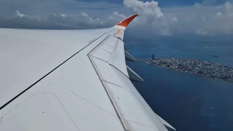 View from the airplane window to the Indian Ocean and the atoll. Maldives Stock Footage 309292304