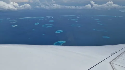 View from the airplane window to the Indian Ocean and the atoll. Maldives Stock Footage 309510233
