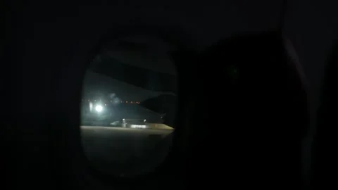 View to airplane window from inside plane cabin while aircraft approaching .. Stock Footage 321288720