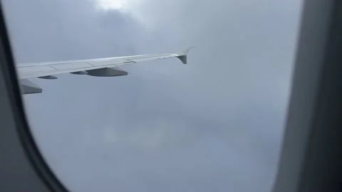 View from airplane window landing in heavy clouds Stock Footage 227132688