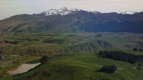 View From Airplane Window Mountain Peaks and Green Valleys With Lake 스톡 동영상 102499668