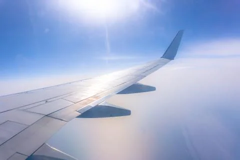 View from the airplane window, ocean blue, sunny day. Vacation concept Stock Photos