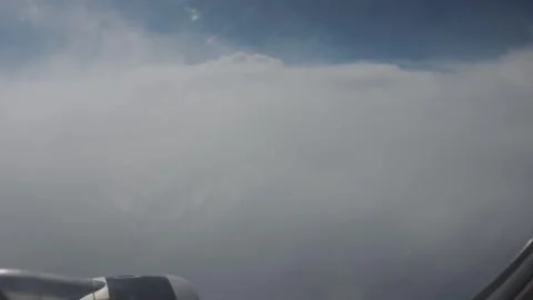 View from airplane window over dense cloud layer in clear sky Stock Footage 335061634