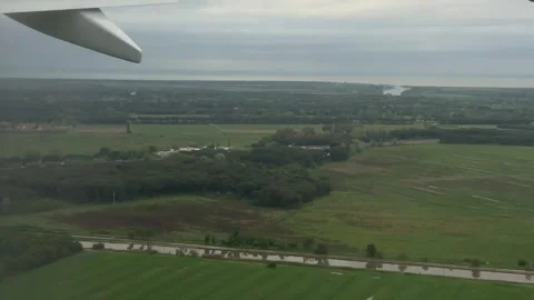 View from airplane window over flooded fields in Pisa on rainy April day Stock Footage 306959871