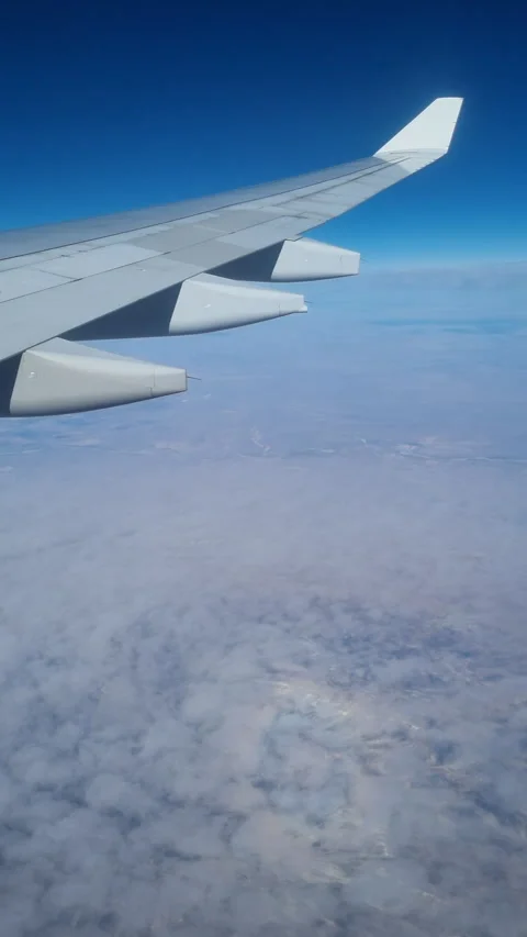 View from an airplane window as a passenger, capturing the wing  Stock Footage 320023746