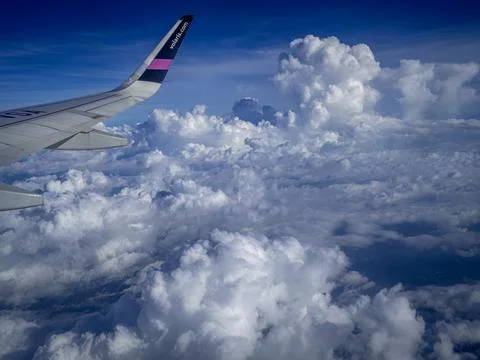 The view from the airplane window on the puffy clouds Stock Photos