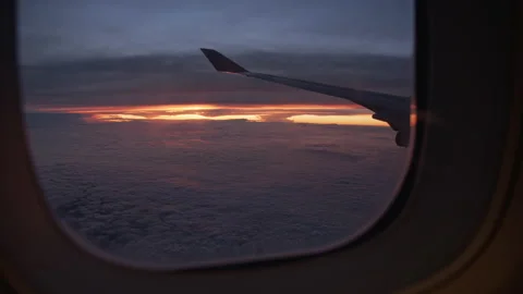 View from the Airplane Window with Scarlet Sunset in Sky Video stock 136064758
