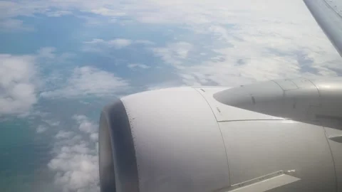 View From Airplane Window Showcasing Engine and Clouds During Daytime Travel Stock Footage 301913498