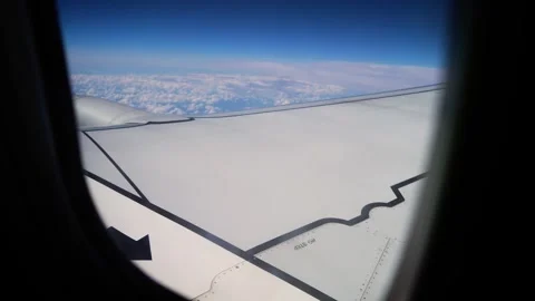 View From Airplane Window Showcasing Wing Soaring Above Clouds on Clear Day in Stock Footage 301912977
