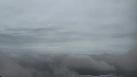 View from airplane window shows overcast sky and clouds from above, drone f.. Stock Footage 337470981